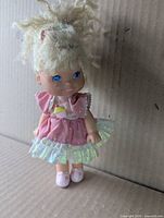 Front view of Cherry Merry Muffin doll standing in outfit