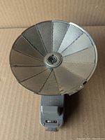 Flash reflector fully opened showing metal blades and central socket