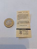 Coin and folded certificate front view