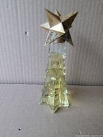 Full view of Avon crystal tree perfume bottle showing shape, cap and liquid level