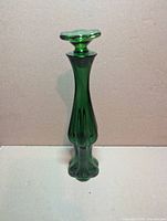 full view of emerald green glass cologne bottle