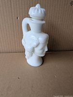 Front view of white milk glass Avon Grecian Pitcher perfume decanter