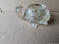 Side view of clear glass turtle showing diamond cut shell and head