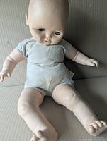 Front view of 22" Star Doll baby doll seated, showing vinyl head, cloth torso, vinyl limbs