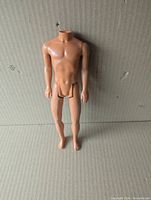 Front view of headless Ken doll body