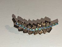 Front view showing baguette amber and round blue rhinestones in gold-tone leaf form