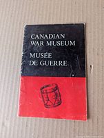 Front cover showing title, bilingual text and drum illustration, visible creasing