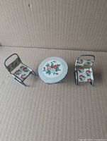 Top view table and two chairs showing floral lithograph design