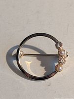 Front view showing circle design, faux pearls and rhinestones