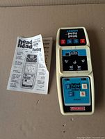 Front view of Coleco Head to Head Hockey game and folded instruction sheet