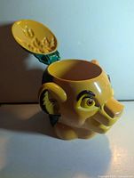 Front angled view of Simba plastic cup with flip lid open showing interior