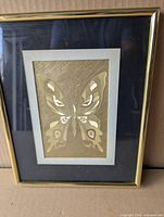 Full view of framed gold foil butterfly piece