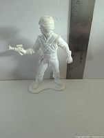 Front view showing overall figure and ruler for scale