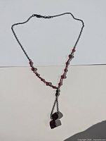 Full view of Y-necklace showing chain, bead arrangement and drop