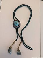 Full bolo tie showing slide, cord and agate tips