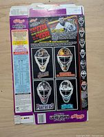 Rear panel with four goalie mask cut-out cards and nutrition panel
