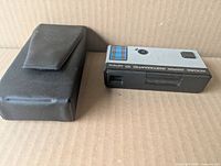 Top view of Kodak Pocket Instamatic 10 camera beside black case