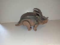 Left side of Eema dinosaur figurine
