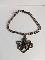 Full view of necklace laid flat showing chain and pendant