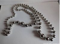 Full view of continuous strand silver-tone plastic beaded necklace