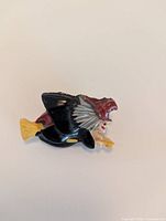 Front view of resin witch brooch showing colours and design