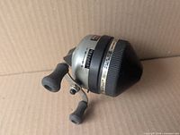 Left side view of Zebco Lancer 808 reel showing handle, model band and overall condition