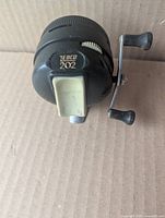 Front view showing Zebco 202 logo and thumb button