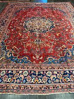 Full view of Mashhad rug showing central medallion and borders
