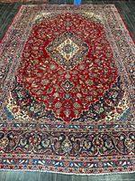 Full view of entire Kashan rug showing central medallion and borders