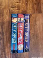 Spines of three City Spies hardcover books in slipcase