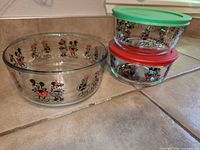 All three Disney Pyrex bowls side by side showing character graphics