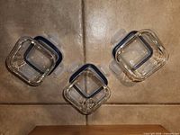Top view of three Ikea square glass containers with lids