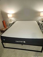 Overall view of Queen Nectar mattress on metal frame
