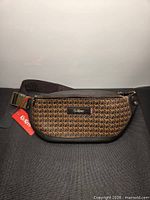 Front view showing pattern, logo patch, hang tag, and strap