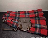 Folded kilt with sporran and strap displayed