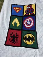 Full view of crocheted throw displaying all six superhero panels