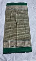 Folded saree showing overall colour and brocade pattern
