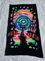 Full view of black tapestry with multicolor psychedelic cat design