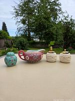 Full lot showing turquoise jar, pink creamer, two white dragon jars with gold lids