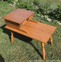 angle view of entire two-tier telephone table outdoors