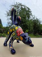 Front three-quarter view of multicolor ceramic monkey figurine