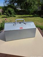 Closed metal toolbox showing handle, lid embossing and Made in Britain sticker