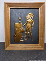 Front view showing full brass-tone relief plaque and wood frame