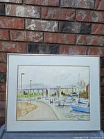 Framed painting full view against brick wall