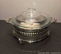 casserole in stand, angled view showing lid and handles