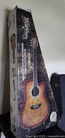 Box showing Washburn sunburst dreadnought cutaway acoustic guitar