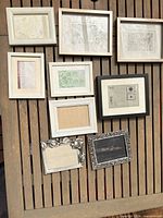 Eight assorted frames on wood backdrop
