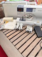 Overall view of sewing machine with accessories and case