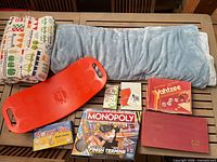 All items laid out: balance board, blankets, board games, flash cards