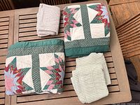 Folded quilt, sheet set, pillowcase on table